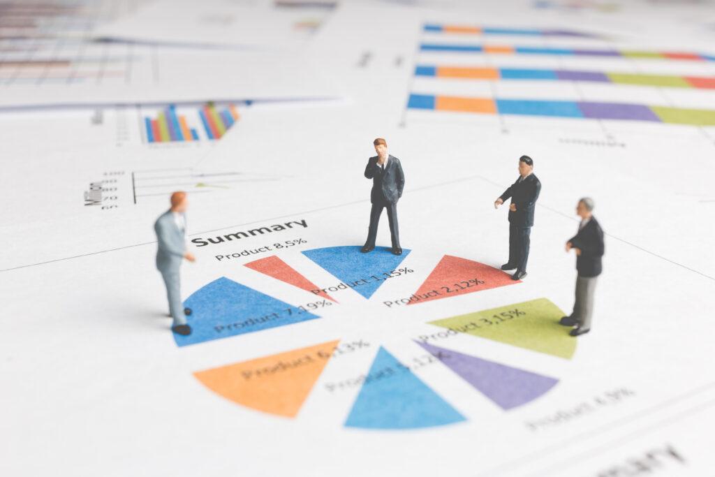 Miniature People : Businessman standing on a Paper graph chart ,Developing a teamwork concept